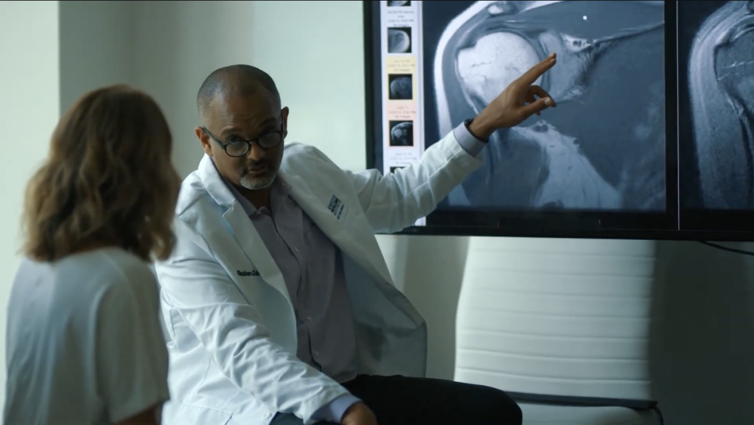 Doctor Examining Patient Shoulder